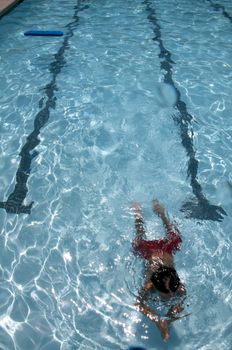 Little boy learning to swim