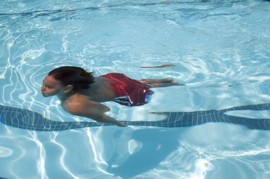 Little boy learning to swim
