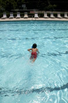 Little boy learning to swim