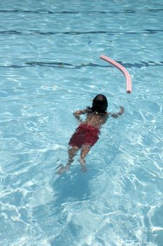 Little boy learning to swim