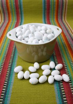 Miniature speckled easter eggs in a green bowl