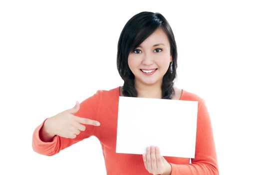 Portrait of an attractive young woman holding blank note card, over white background.