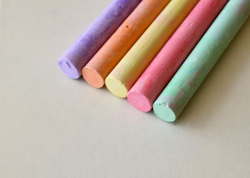 Blackboard chalk in various colors on a cream colored surface