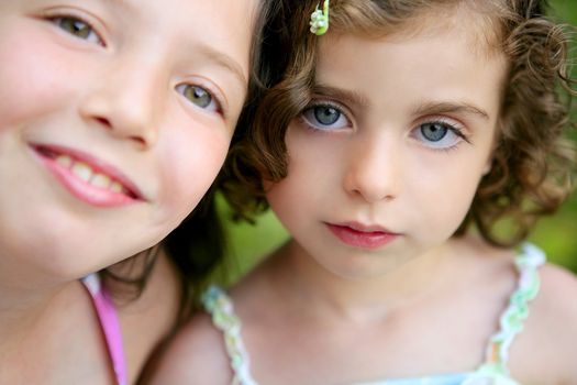 closeup portrait of two little happy beautiful girl sisters