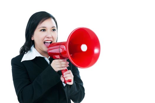 Portrait of an attractive businesswoman using a loudhailer, over white background.