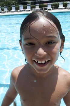 Little boy playing at pool
