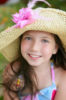 Closeup portrait of beautiful teen little girl with hat in the park