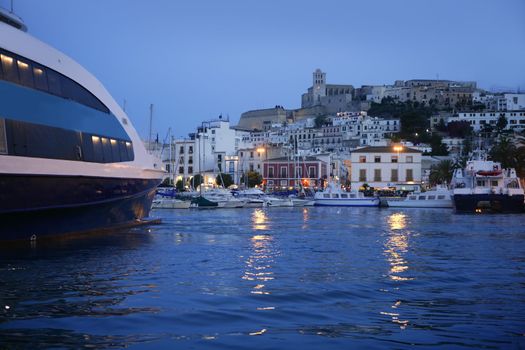 Ibiza island harbor and city under night light in Mediterranean sea