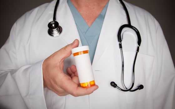 Male Doctor with Stethoscope and Blank Medicine Bottle.