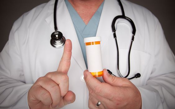 Male Doctor with Stethoscope and Blank Medicine Bottle.