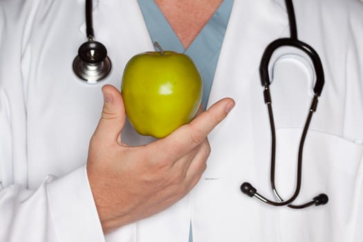 Male Doctor with Stethoscope Holding Green Apple.