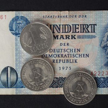 100 Mark banknote from the DDR (East Germany) with 1 Mark coin - Note: no more in use since german reunification in 1989