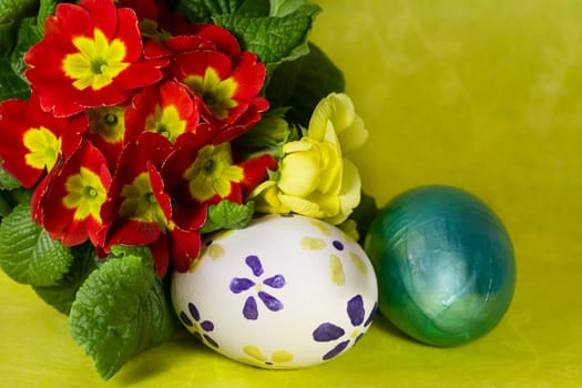 Colorful painted Easter eggs with primrose