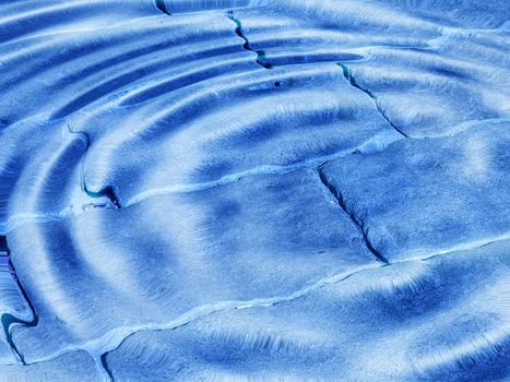 Swimming pool tiles underwater useful as a background