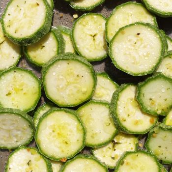 Green courgettes or zucchini vegetables useful as a background