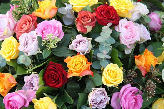 Floral arrangement with roses in various colors