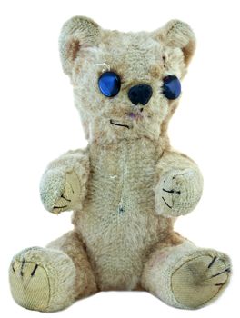 Old teddy bear; faded, worn, repaired, but still loved