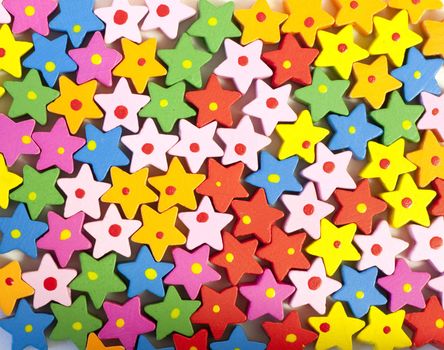 Background of many colorful painted wooden bead stars