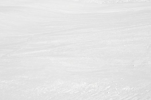 Clean white snowy background with faint ski tracks