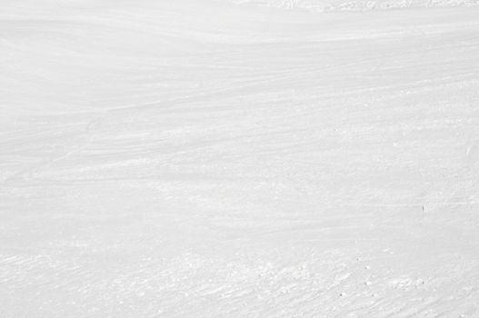 Clean white snowy background with faint ski tracks