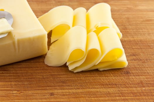 Picture of cheese sliced on a used board