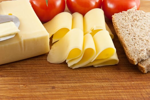 Picture of some cheese with tomatoes and bread