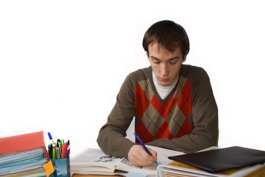 Male student at a table, writes