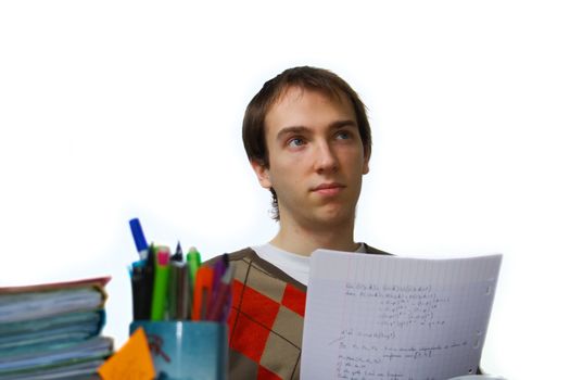 Male student at a table daydreaming