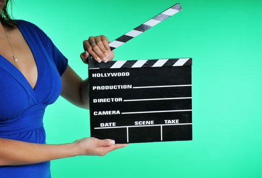 woman holding a clapper board on a green screen