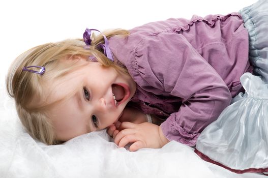 A little girl lying on the floor in studio