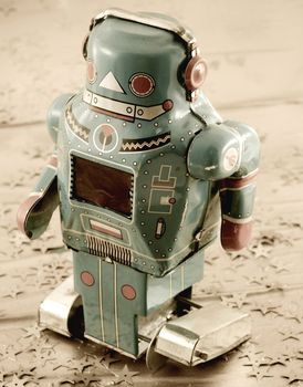 retro robot toy on gold backfround