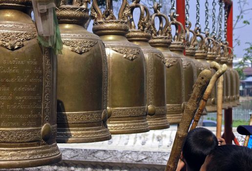 children and buddhist temple bells