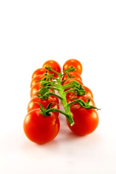 Cherry tomatoes on the vine with clipping path on a white background