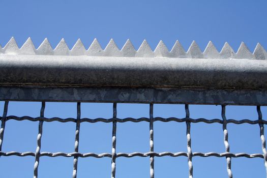 metal fence with with edges and tines