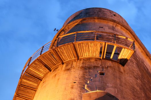 bastion lit by a floodlight at night