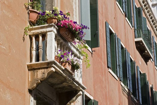 A small balcony with flowers on a typical Italien house. Location: Venice, Italy
