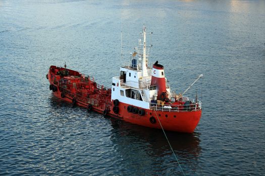 a small oil tanker boat also known as a bunkering barge