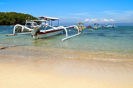 Beach with anchored traditional boats in Gili island