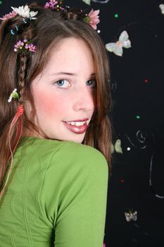Teenage model with flowers and butterflies in her hair