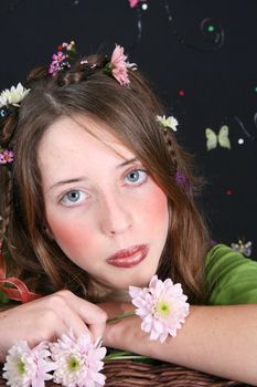 Teenage model with flowers and butterflies in her hair