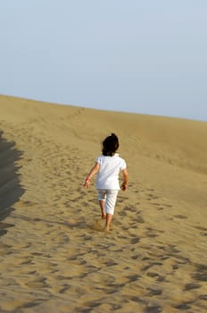 Child is walking alone in the desert