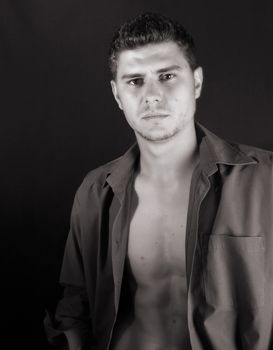 Male model in studio against black background