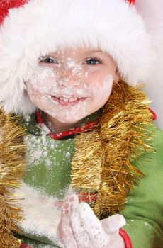 Toddler wearing a christmas hat, baking christmas cookies