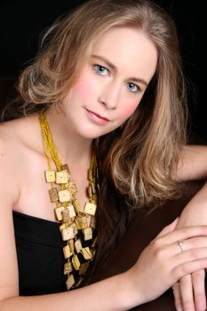 Beautiful female model with blue eyes wearing jewelery
