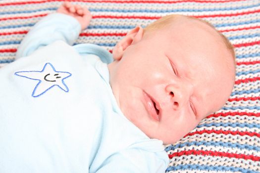 Month old baby boy on a colorful blanket 