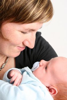 Loving mother holding her new baby boy