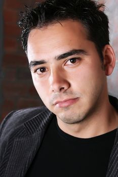 Male model against a rough brick wall background