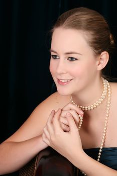 Beautiful female wrapped in fabric, wearing pearls