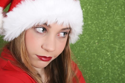 Teenager with red lips wearing a christmas hat