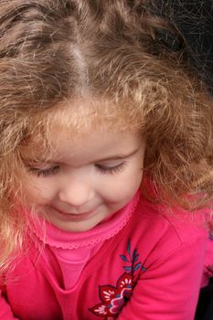 Beautiful young girl with curly hair and cute features
